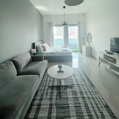 a living room with a couch and a table at Studio with Marina Breeze in Dubai