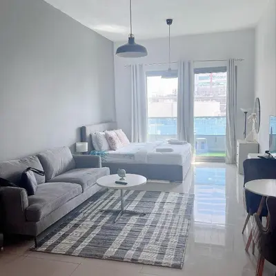 a living room with a couch and a table at Studio with Marina Breeze in Dubai