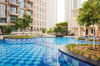 a swimming pool in a city with tall buildings at Sophisticated Studio near Burj Khalifa in Dubai