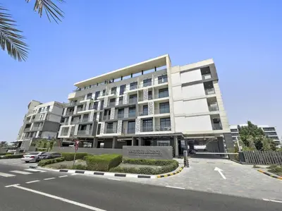 a large building with a sign in front of it at Luxury Studio Apartments at Majestique Residence in Dubai