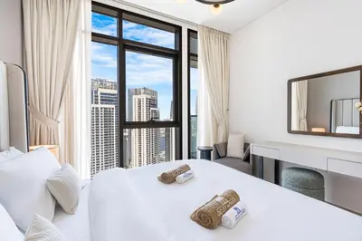 a bedroom with a white bed and a large window at Stunning Home in Palace Residences on 41st Floor in Dubai