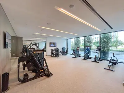a gym with treadmills and exercise equipment in a building at Stunning Home in Palace Residences on 41st Floor in Dubai