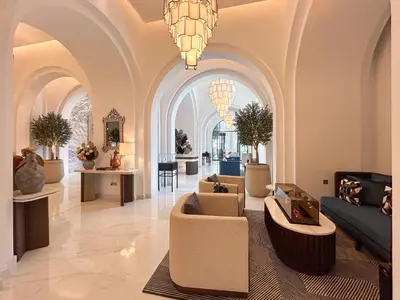 a lobby with a couch and chairs and a chandelier at Stunning Home in Palace Residences on 41st Floor in Dubai