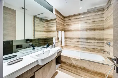 a bathroom with a sink and a tub at Cute studio in The Sterling by Omniyat in Dubai