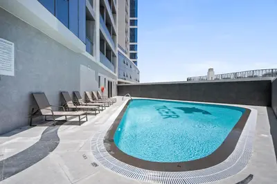 a swimming pool on the side of a building at Spacious Studio With Dubailand Charm in Dubai