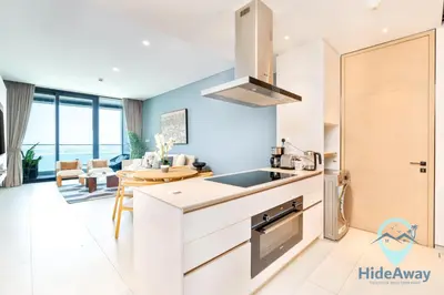 a kitchen with a sink and a living room at 3BR Best SeaView JBR Address Beach Resort in Dubai