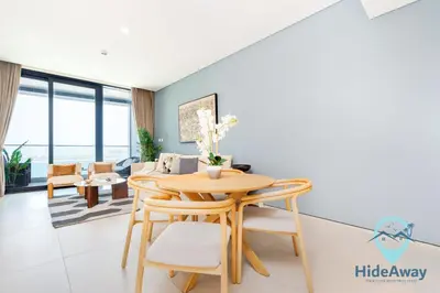 a living room with a wooden table and chairs at 3BR Best SeaView JBR Address Beach Resort in Dubai