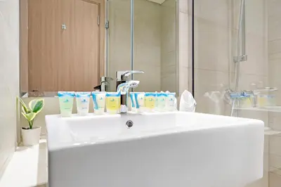 a white sink in a bathroom with a shower at Cozy 1BR with Pool View & Balcony in Dubai