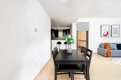 a dining room with a black table and chairs at 1-BR Stunning Sea View Beachfront JBR in Dubai