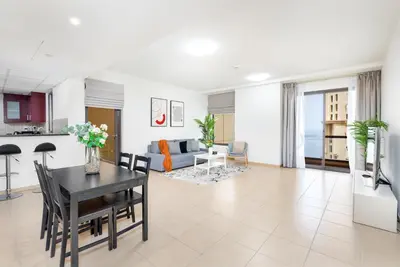 a living room with a table and a dining room at 1-BR Stunning Sea View Beachfront JBR in Dubai