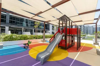 a playground with a slide in a building at Cozy studio in Azizi Riviera with beautiful views in Dubai