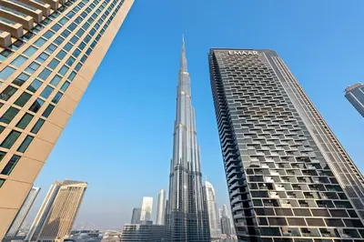 a view of the empire state building between two tall buildings at Luxury 2BR Burj View with Pool Walk to Mall & Metro Dining Shopping in Dubai
