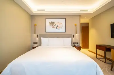 a large white bed in a hotel room at NewArabian Opera Address Residences in Dubai