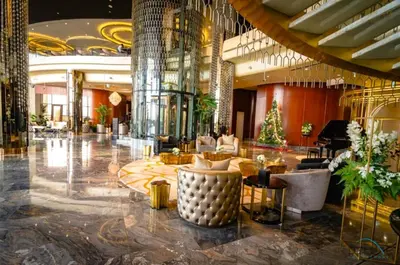 a hotel lobby with a christmas tree in the center at Stylish 1BR in Damac Towers by Paramount B, Business Bay by Deluxe Holiday Homes in Dubai