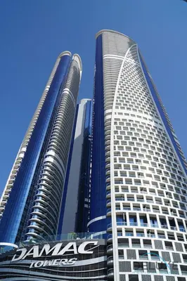 two tall buildings with the nissan logo on them at Stylish 1BR in Damac Towers by Paramount B, Business Bay by Deluxe Holiday Homes in Dubai