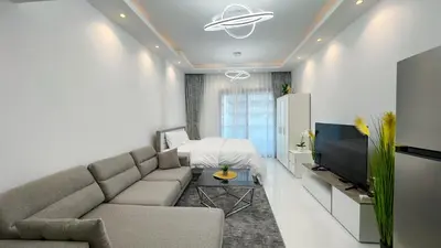 a living room with a couch and a tv at Dubai Marina - Stylish Studio Apartment - Marina Diamond 2 in Dubai