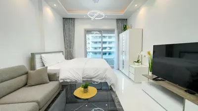 a living room with a couch and a tv at Dubai Marina - Stylish Studio Apartment - Marina Diamond 2 in Dubai