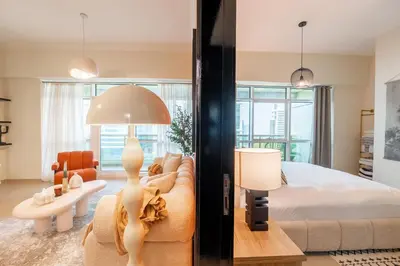 a living room with a bed and a couch at Stylish 1BR Apartment! Near Metro & Stroll to Dubai Marina in Dubai
