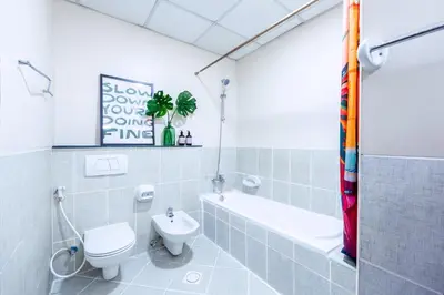 a bathroom with a toilet and a tub and a sink at Stylish 1BR Apartment! Near Metro & Stroll to Dubai Marina in Dubai