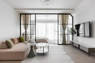 a living room with a couch and a table at Studio apartment MeDoRe Tower in Dubai