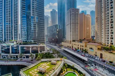 a city with a highway and buildings and traffic at ShoresInn - Mesmerizing Waterfront in Dubai Marina in Dubai