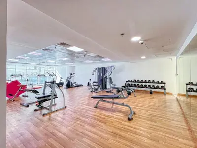 a gym with treadmills and machines in a room at ShoresInn - Mesmerizing Waterfront in Dubai Marina in Dubai