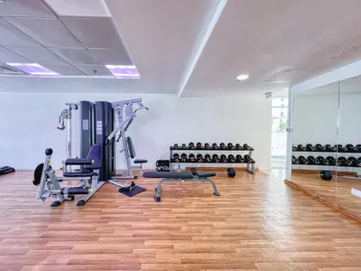 a gym with treadmills and machines in a room at ShoresInn - Mesmerizing Waterfront in Dubai Marina in Dubai