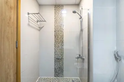 a bathroom with a shower with a glass door at ShoresInn - Mesmerizing Waterfront in Dubai Marina in Dubai