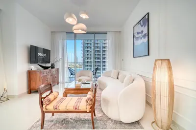 a living room with a couch and a table at Chic 2BR with Iconic Dubai Eye and Palm Views in Dubai