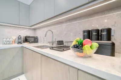 a bowl of fruit on a counter in a kitchen at Chic 2BR with Iconic Dubai Eye and Palm Views in Dubai
