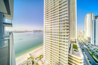 a view of the ocean from the balcony of a tall building at Chic 2BR with Iconic Dubai Eye and Palm Views in Dubai