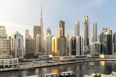 a city skyline with a river and buildings at Waves - Stylish 13th-Floor Studio with Top-Notch Amenities in Dubai