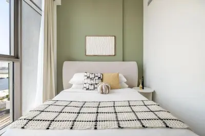 a bedroom with a white bed with a black and white blanket at GuestReady - Luxurious paradise in Dubai in Dubai