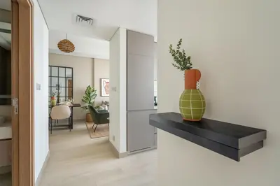 a living room with a vase on a black counter at GuestReady - Luxurious paradise in Dubai in Dubai