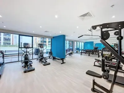 a gym with treadmills and machines in a building at Azizi Riviera 18 - Neat One Bedroom in Meydan in Dubai