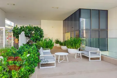 a balcony with chairs and plants on a building at Lux 1BR Direct access to Dubai Marina 4 people in Dubai