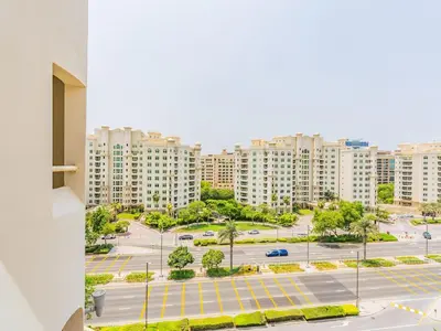 a view of a parking lot in a city at Chic 4BR Apt Pool Palm Beach Club Dubai in Dubai