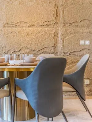 a dining room with a table with chairs at Chic 4BR Apt Pool Palm Beach Club Dubai in Dubai