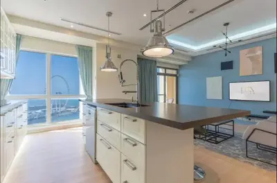 a large kitchen with a large island with a sink at AWS Holiday Homes - Spectacular Sea Views in Dubai