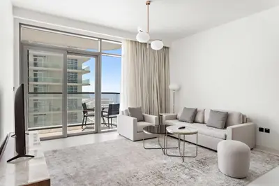 a living room with a couch and a table at Silkhaus 1BDR with Beach Access in Marina Vista in Dubai