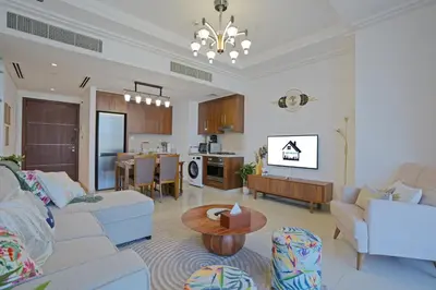a living room with a couch and a table at CH Urban Haven - 1BR at Boulevard Point with Burj & Fountain Views in Dubai