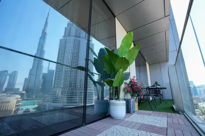 a balcony with a view of a city at CH Urban Haven - 1BR at Boulevard Point with Burj & Fountain Views in Dubai