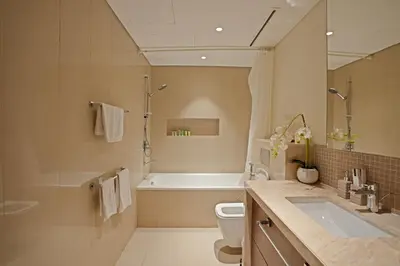 a bathroom with a tub and a toilet and a sink at CH Urban Haven - 1BR at Boulevard Point with Burj & Fountain Views in Dubai