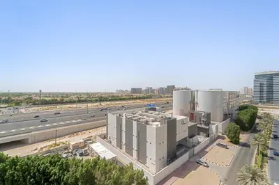 an aerial view of a building and a highway at Silkhaus Modern Studio in Reef Residence at JVC in Dubai