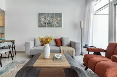 a living room with a couch and a table at ShoresInn - Artistic Retreat in Dubai Marina in Dubai