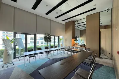 a dining room with a long table and chairs at Vida Dubai Marina Residences in Dubai