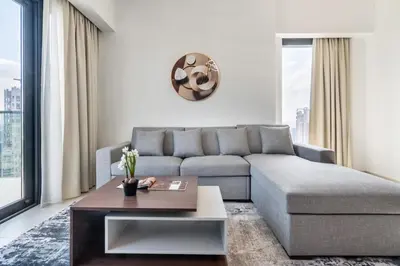 a living room with a couch and a coffee table at Luxurious 2BDR Apartment with Burj Khalifa Views in Dubai