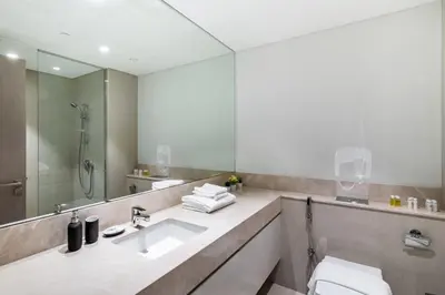 a bathroom with a sink and a mirror at Luxurious 2BDR Apartment with Burj Khalifa Views in Dubai