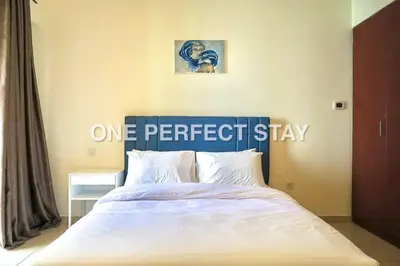 a bedroom with a bed with a one perfectstay sign on it at Cozy 2 Bedroom at JBR Beachfront With Pool And Gym in Dubai