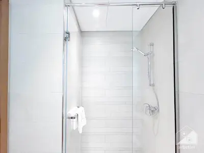 a shower stall with a glass door and a shower at Cozy Studio with Balcony & Stunning Views in Dubai